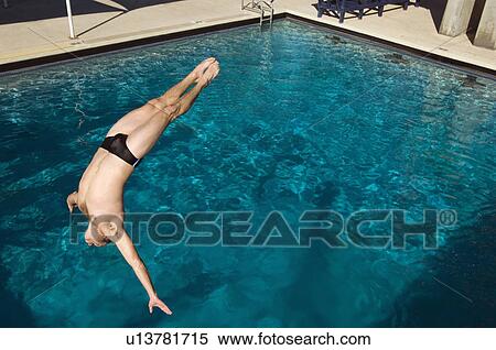 Young man diving into swimming pool View Large Photo Image Stock Photography - Young man diving into swimming pool. Fotosearch