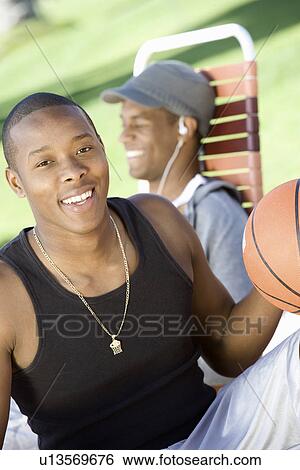 Young Man Holding Basketball, Relaxing with Friend View Large Photo Image Stock Photograph - Young Man Holding Basketball, Relaxing with Friend. Fotosearch