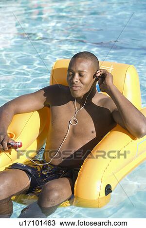 Young Man Listening to Music in Swimming Pool View Large Photo Image Stock Image - Young Man Listening to Music in Swimming Pool. Fotosearch