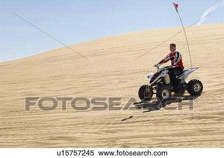 Young Man on ATV on Sand Dune View Large Photo Image Stock Photography - Young Man on ATV on Sand Dune. Fotosearch