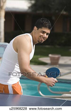 Stock Photo - Young Man Playing Table Tennis Outdoors. Fotosearch