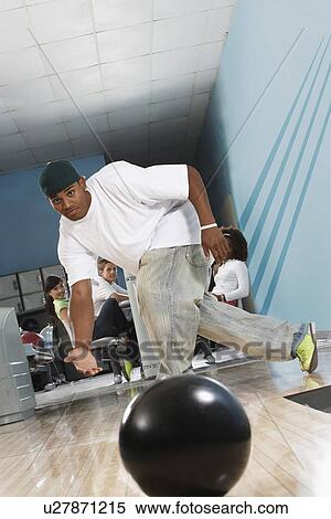 Young man releasing bowling ball, portrait View Large Photo Image Stock Photography - Young man releasing bowling ball, portrait. Fotosearch