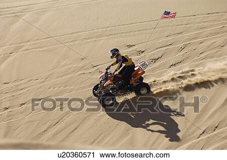 Young Man Riding ATV Over Sand Dune View Large Photo Image Stock Image - Young Man Riding ATV Over Sand Dune. Fotosearch