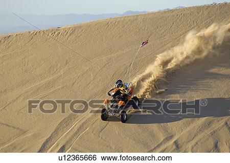 Young Man Riding ATV Over Sand Dune View Large Photo Image Stock Photograph - Young Man Riding ATV Over Sand Dune. Fotosearch