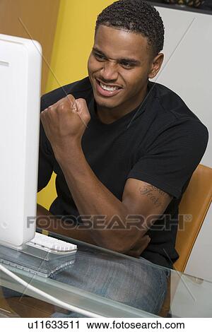 Young Man Using Desktop Computer View Large Photo Image Stock Image - Young Man Using Desktop Computer. Fotosearch
