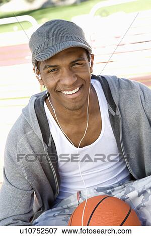 Stock Photo - Young Man with Basketball, Portrait. Fotosearch