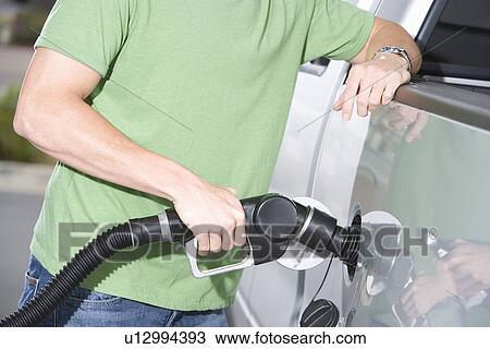 Young man with fuel pump, mid section View Large Photo Image Stock Image - Young man with fuel pump, mid section. Fotosearch