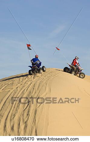 Young Men Riding ATVs Over Sand Dunes View Large Photo Image Stock Image - Young Men Riding ATVs Over Sand Dunes. Fotosearch