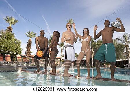 Stock Image - Young People Dancing at a Pool Party. Fotosearch