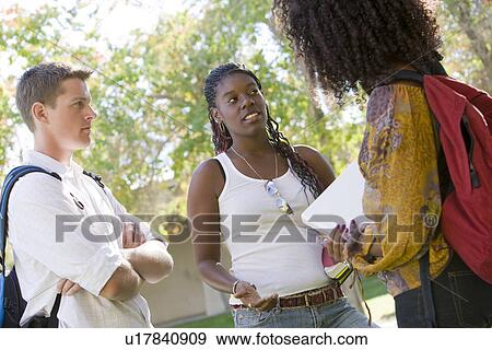 Stock Photo - Young students having a chat. Fotosearch
