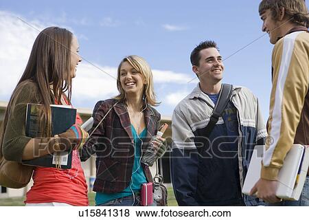 Stock Photo - Young students having chat. Fotosearch
