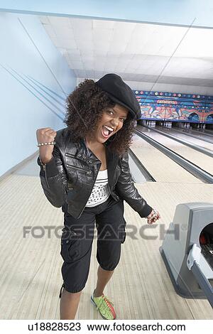 Young woman at bowling alley celebrating, portrait View Large Photo Image Stock Image - Young woman at bowling alley celebrating, portrait. Fotosearch