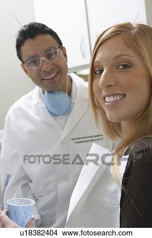 Picture - Young woman at dentists office, smiling, (portrait). Fotosearch