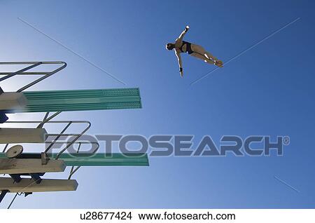 Young woman diving from diving board View Large Photo Image Picture - Young woman diving from diving board. Fotosearch
