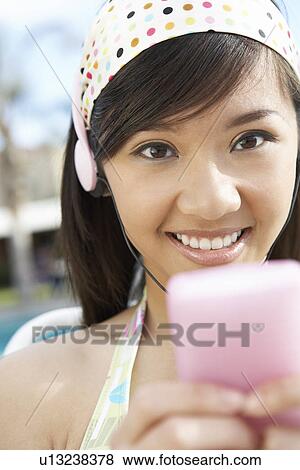 Young Woman Listening to mp3 player View Large Photo Image Stock Photo - Young Woman Listening to mp3 player. Fotosearch