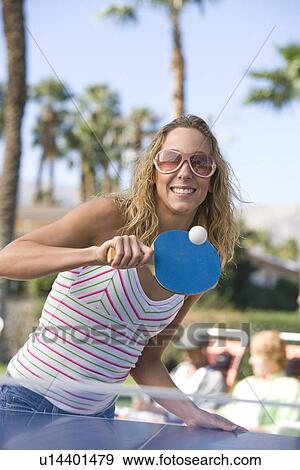 Young woman playing table tennis, portrait View Large Photo Image Stock Photo - Young woman playing table tennis, portrait. Fotosearch