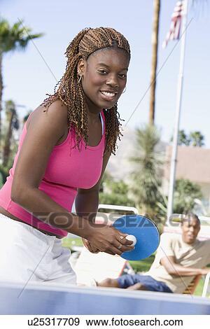 Young woman playing table tennis, portrait View Large Photo Image Stock Photo - Young woman playing table tennis, portrait. Fotosearch