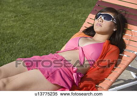 Stock Photography - Young Woman Relaxing in Park. Fotosearch