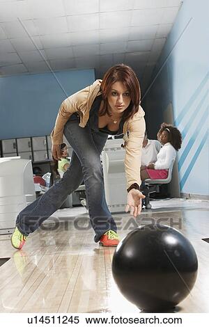 Young woman releasing bowling ball, portrait View Large Photo Image Stock Photography - Young woman releasing bowling ball, portrait. Fotosearch