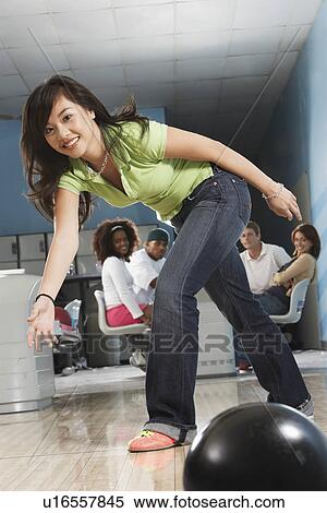 Young woman releasing bowling ball, portrait View Large Photo Image Stock Photography - Young woman releasing bowling ball, portrait. Fotosearch