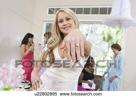 Stock Photography - Young woman showing engagement ring. Fotosearch