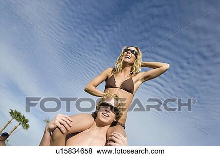 Young Woman Sitting on Mans Shoulders View Large Photo Image Stock Photo - Young Woman Sitting on Mans Shoulders. Fotosearch