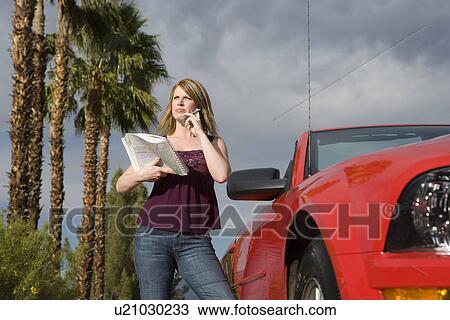 Stock Image - Young Woman Using Cell Phone. Fotosearch
