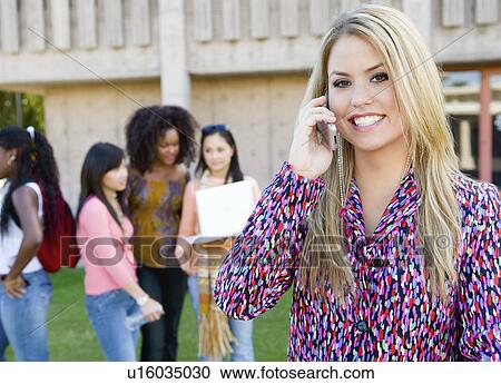 Young woman using mobile phone outdoors View Large Photo Image Stock Image - Young woman using mobile phone outdoors. Fotosearch