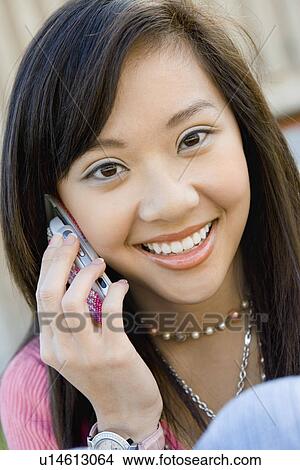 Picture - Young woman using mobile phone, (close-up), (portrait). Fotosearch