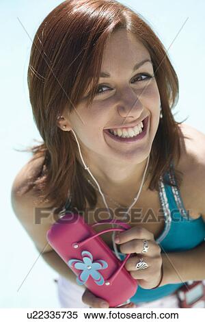 Stock Photography - Young Woman with Pink Purse Smiling, Portrait. Fotosearch