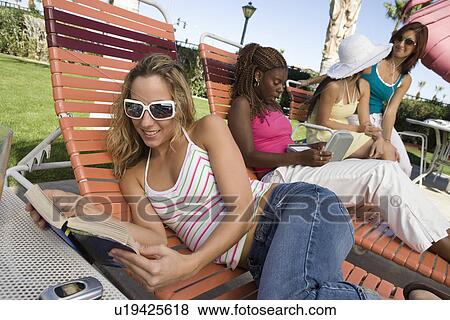 Stock Photo - Young women relaxing outdoors. Fotosearch