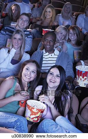 Young women sharing popcorn, Watching Movie Together View Large Photo Image Stock Image - Young women sharing popcorn, Watching Movie Together. Fotosearch
