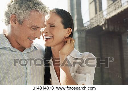 Stock Image - Affectionate couple embracing outdoors. Fotosearch