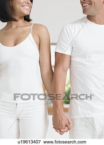 Affectionate Young Couple Holding Hands View Large Photo Image Stock Photo - Affectionate Young Couple Holding Hands. Fotosearch