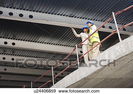 Architect and construction manager on site View Large Photo Image Stock Photo - Architect and construction manager on site. Fotosearch