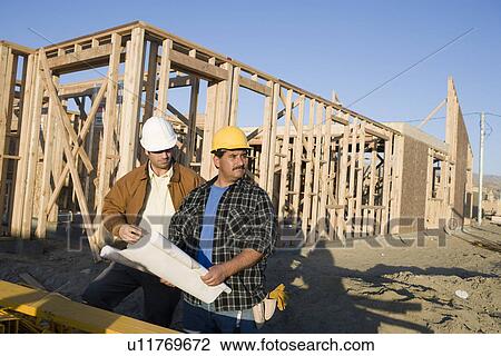Architect with construction worker in construction site View Large Photo Image Stock Image - Architect with construction worker in construction site. Fotosearch