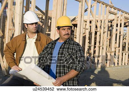 Architect with construction worker in construction site View Large Photo Image Stock Image - Architect with construction worker in construction site. Fotosearch