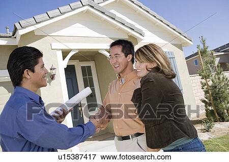 Architect with couple, shaking hands View Large Photo Image Stock Photo - Architect with couple, shaking hands. Fotosearch
