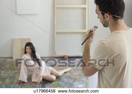 Stock Photo - Artist Observing Artist's Model in Studio. Fotosearch
