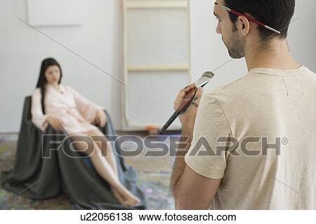 Stock Photo - Artist Observing Artist's Model in Studio. Fotosearch
