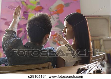 Picture - Artists Discussing Painting in Studio. Fotosearch