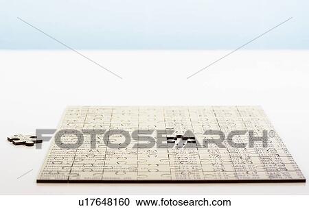 Stock Image - Assembled jigsaw puzzle with missing piece. Fotosearch