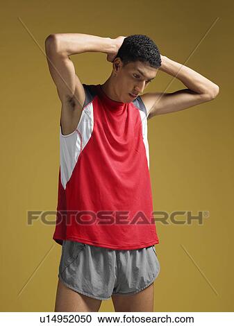 Athlete standing with hands behind head View Large Photo Image Stock Image - Athlete standing with hands behind head. Fotosearch