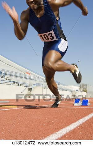 Stock Image - Athlete starting to run. Fotosearch