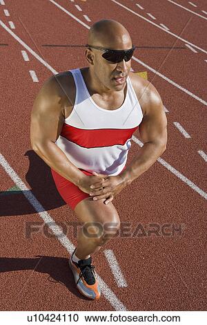 Athlete warming up before run View Large Photo Image Stock Image - Athlete warming up before run. Fotosearch