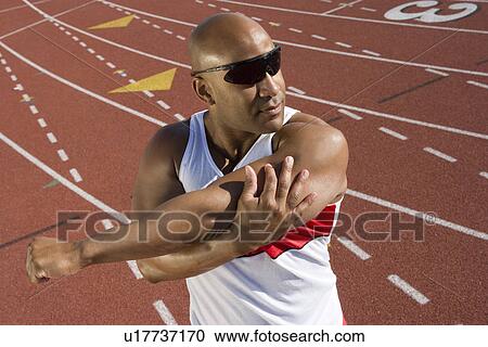 Athlete warming up before run View Large Photo Image Stock Image - Athlete warming up before run. Fotosearch