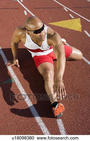 Athlete warming up before run View Large Photo Image Stock Image - Athlete warming up before run. Fotosearch