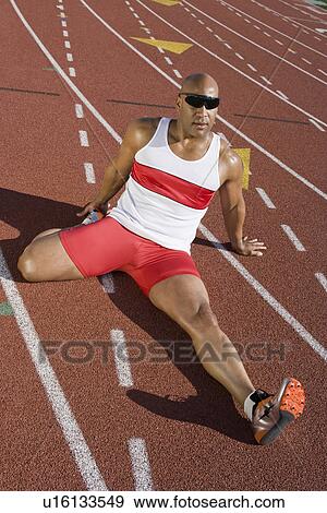 Stock Photo - Athlete warming up before run. Fotosearch