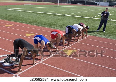 Picture - Athletes ready to run, high angle view. Fotosearch