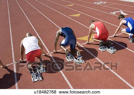 Athletes ready to run, high angle view View Large Photo Image Stock Photo - Athletes ready to run, high angle view. Fotosearch